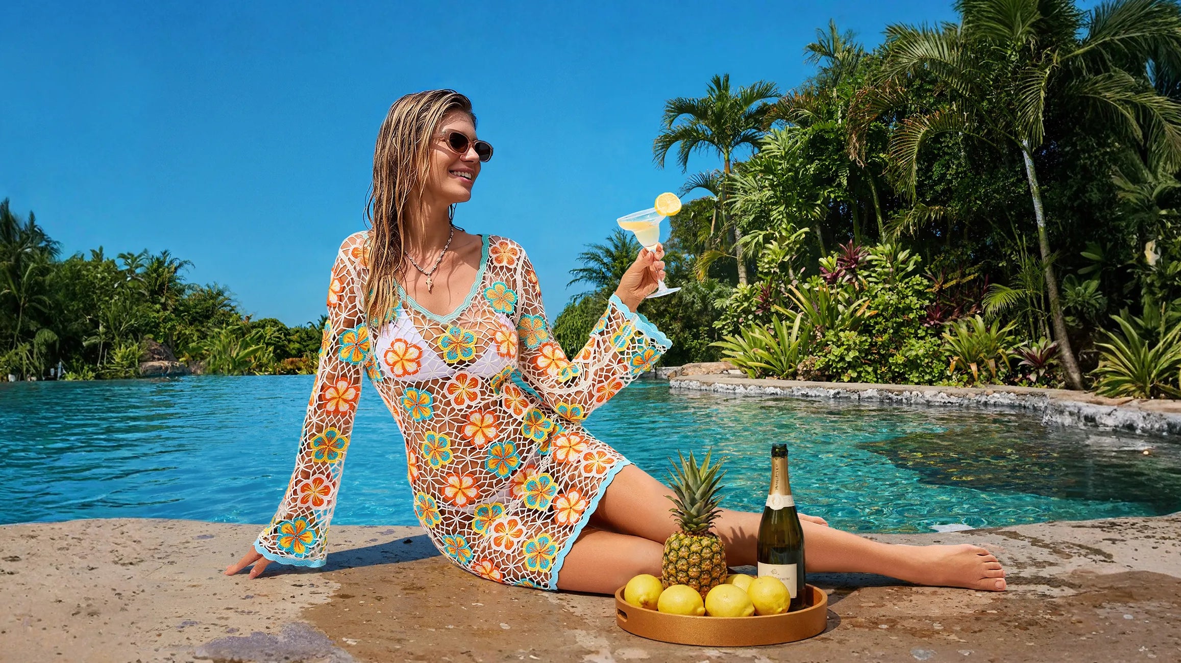 Retro floral hollow knit long sleeve beach cover up dress, female model lounging at resort pool with cocktail, tropical summer vacation swim coverup wear