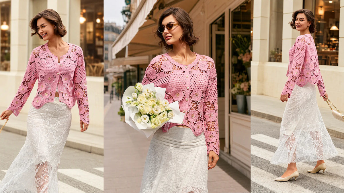 Woman wearing a pink crochet cardigan layered over a white lace midi skirt, styled for transitional season fashion on a city street