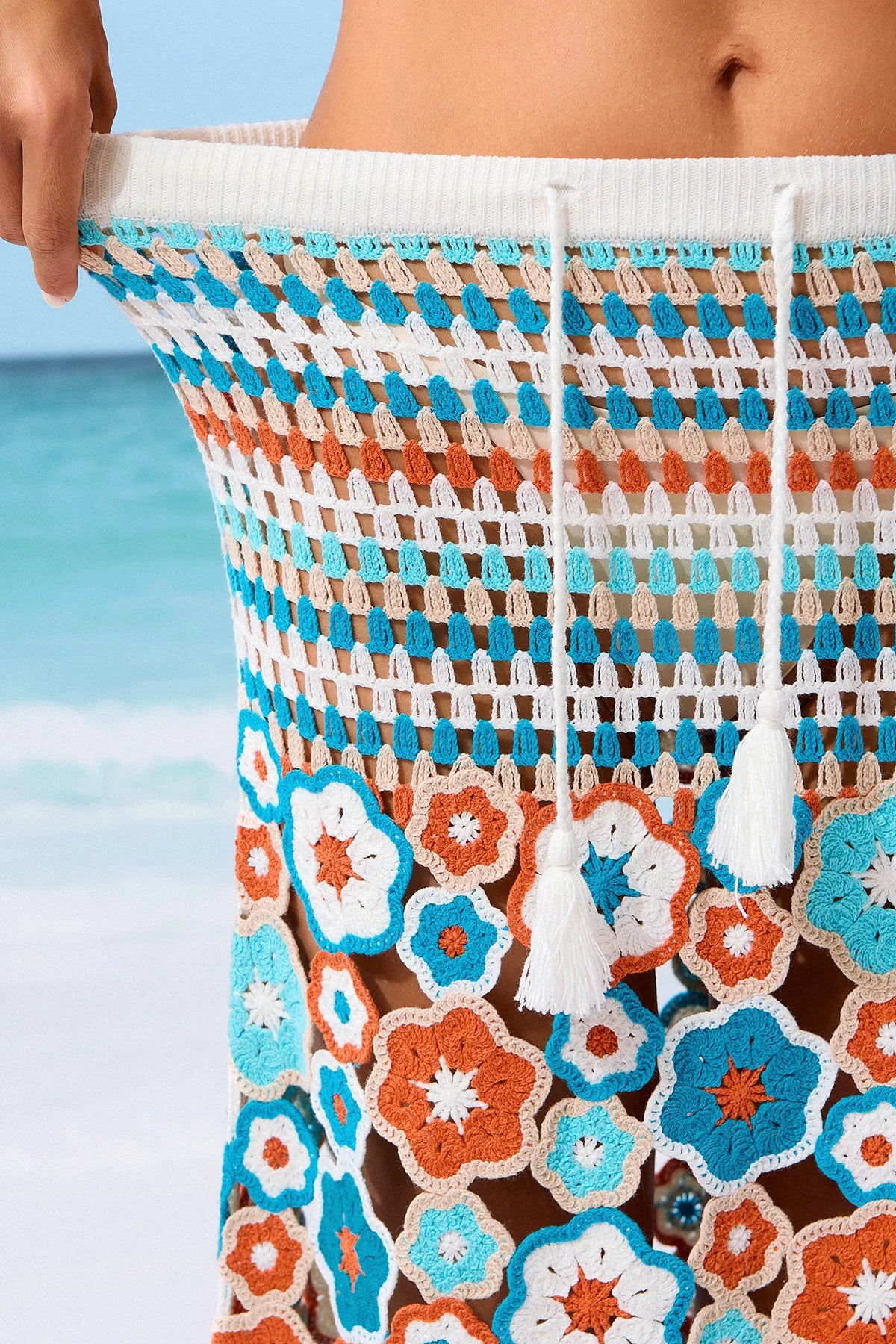 Close-up of a colorful floral-patterned bag with a beach background