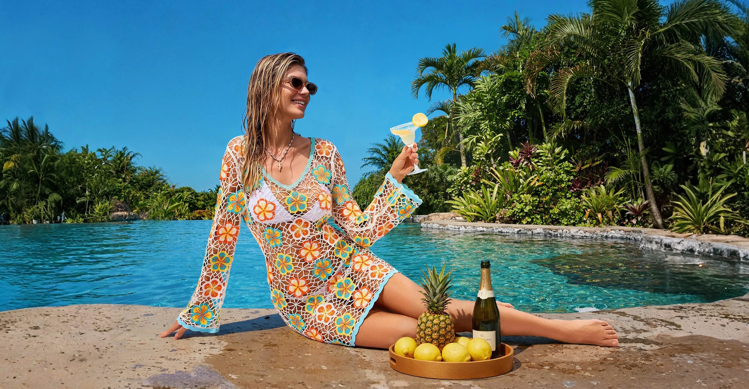 Retro floral hollow knit long sleeve beach cover up dress, female model lounging at resort pool with cocktail, tropical summer vacation swim coverup wear