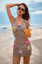 Woman in a crochet dress with starfish patterns on a beach