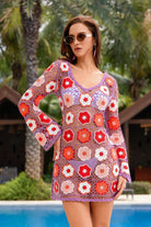 Woman wearing a colorful crochet dress with a floral pattern by a poolside.