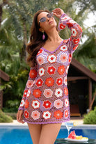 Woman wearing a colorful crochet dress by a poolside