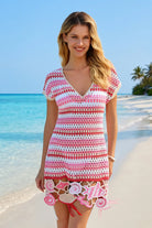 Woman wearing a colorful striped dress on a beach