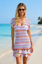 Woman wearing a colorful crochet cover-up on a beach